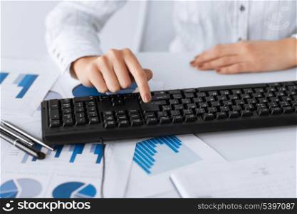 picture of woman hand pressing enter button on keyboard