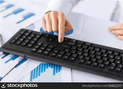 picture of woman hand pressing enter button on keyboard
