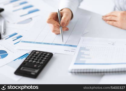 picture of woman hand with calculator and papers