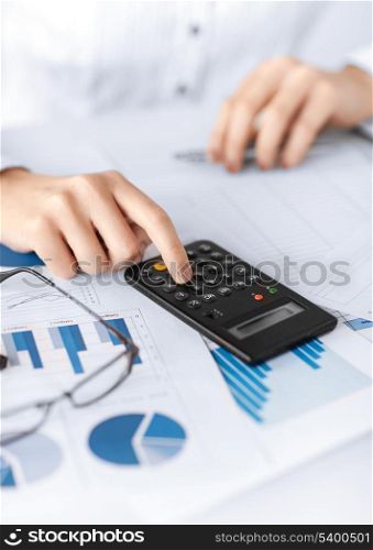 picture of woman hand with calculator and papers