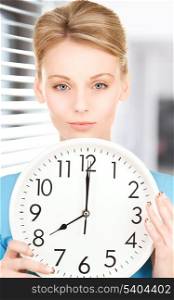 picture of woman holding big clock