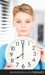 picture of woman holding big clock