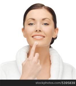 picture of woman in bathrobe applying cream
