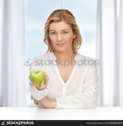 picture of woman in casual clothes with green apple