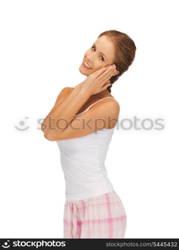 picture of woman in cotton pajamas making sleeping gesture