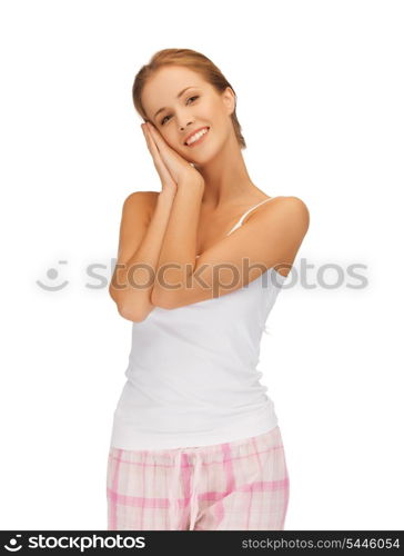 picture of woman in cotton pajamas making sleeping gesture