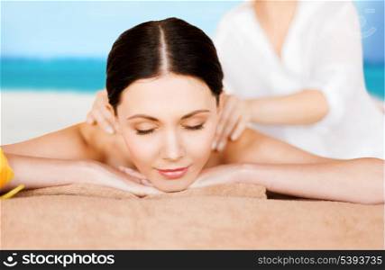 picture of woman in spa salon getting massage on the beach