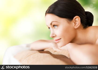 picture of woman in spa salon lying on the massage desk