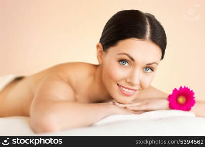 picture of woman in spa salon lying on the massage desk