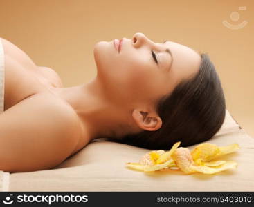 picture of woman in spa salon lying on the massage desk