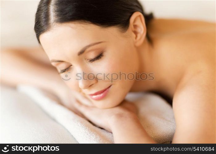 picture of woman in spa salon lying on the massage desk