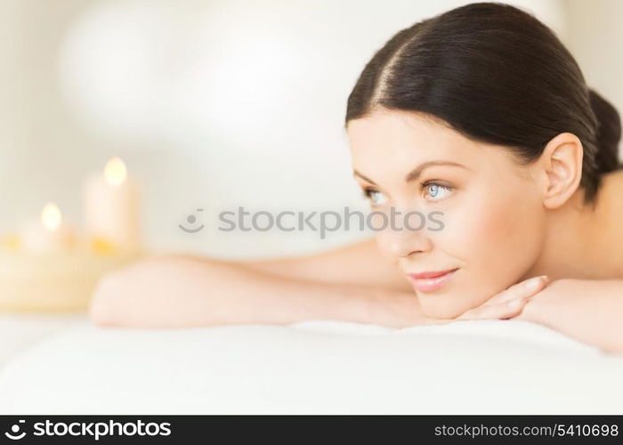 picture of woman in spa salon lying on the massage desk