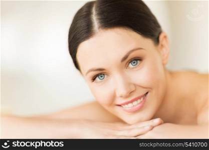 picture of woman in spa salon lying on the massage desk