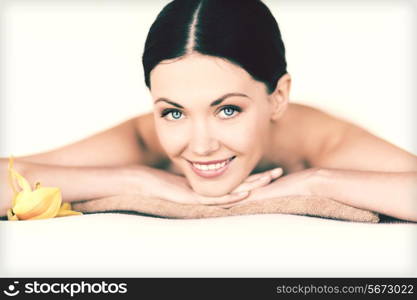 picture of woman in spa salon lying on the massage desk