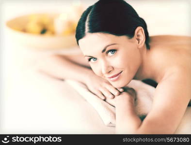 picture of woman in spa salon lying on the massage desk