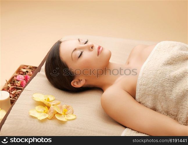 picture of woman in spa salon lying on the massage desk. woman in spa salon lying on the massage desk