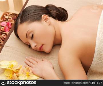 picture of woman in spa salon lying on the massage desk. woman in spa salon lying on the massage desk