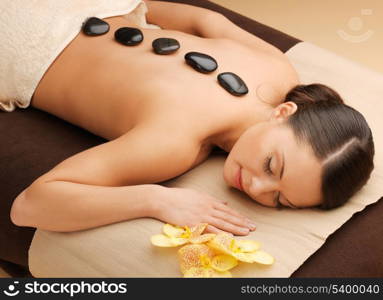 picture of woman in spa salon with hot stones