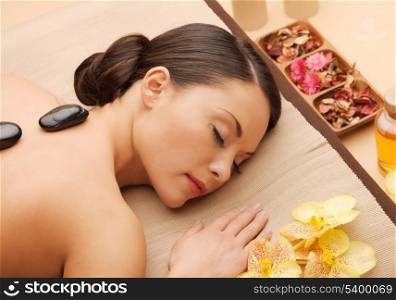picture of woman in spa salon with hot stones