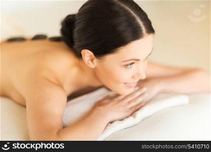 picture of woman in spa salon with hot stones