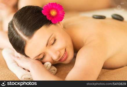 picture of woman in spa salon with hot stones