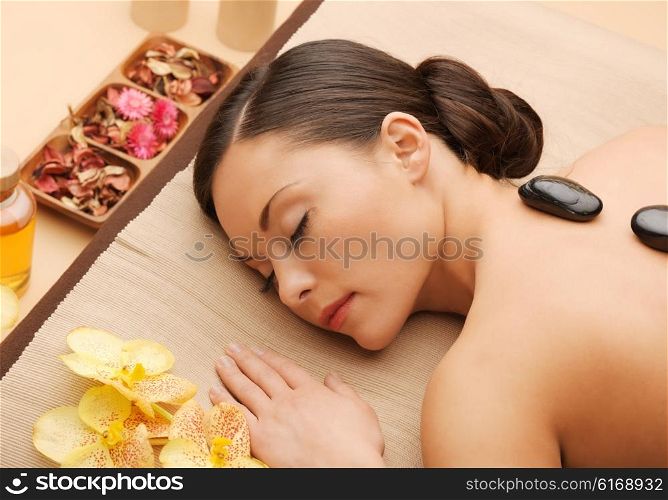 picture of woman in spa salon with hot stones. beautiful woman with hot stones