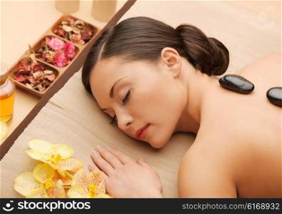 picture of woman in spa salon with hot stones. beautiful woman with hot stones