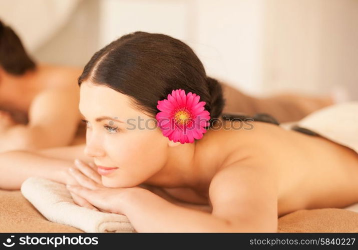 picture of woman in spa salon with hot stones. woman in spa with hot stones