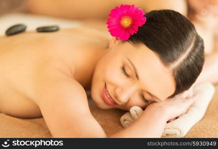 picture of woman in spa salon with hot stones. woman in spa with hot stones