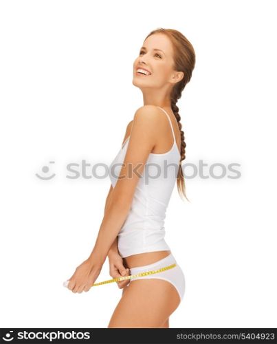 picture of woman measuring her hips with measuring tape