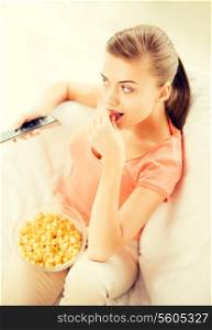 picture of woman watching tv and eating popcorn