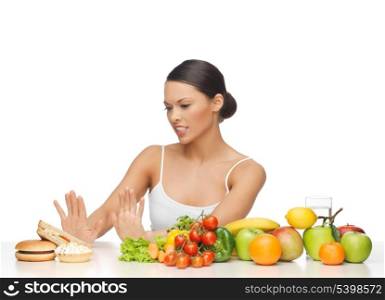picture of woman with fruits rejecting hamburger