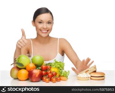 picture of woman with fruits showing thumbs up. woman with fruits showing thumbs up