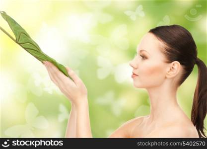 picture of woman with green leaf