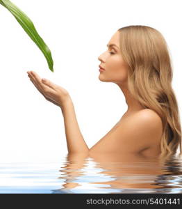 picture of woman with green leaf in water