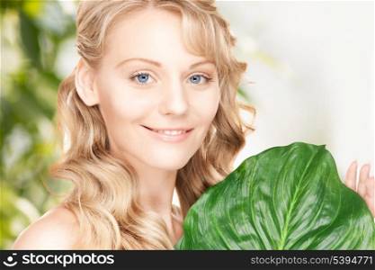picture of woman with green leaf over natural background