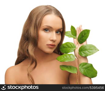 picture of woman with green leaf over white.