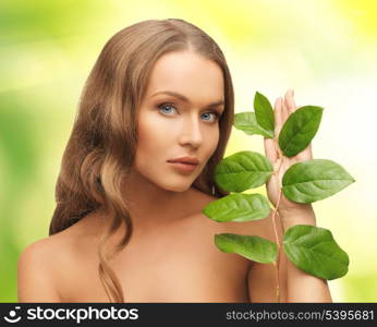 picture of woman with green leaf over white.