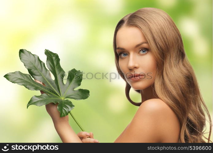 picture of woman with green leaf over white