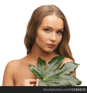 picture of woman with green leaf over white.