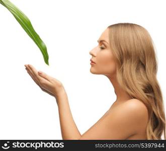 picture of woman with green leaf over white.