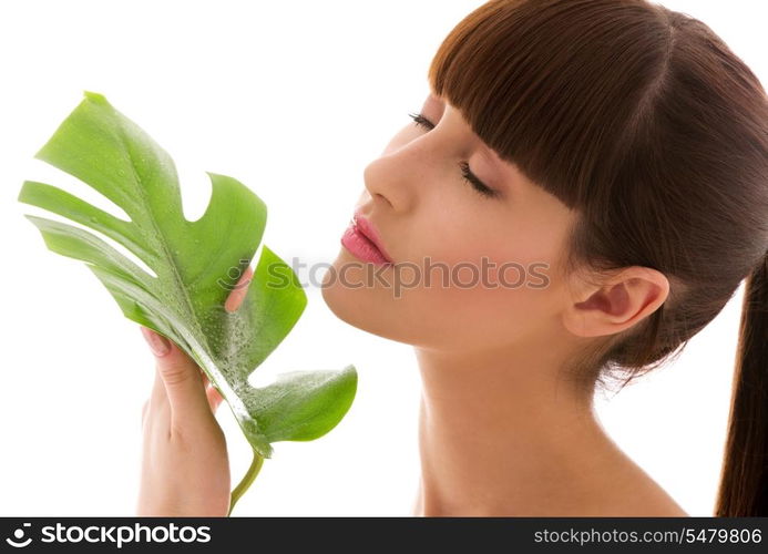 picture of woman with green leaf over white