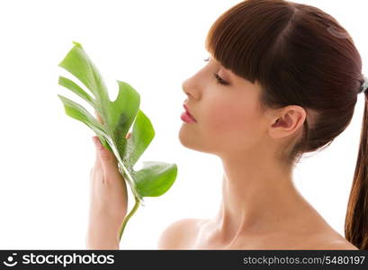 picture of woman with green leaf over white