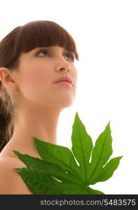 picture of woman with green leaf over white