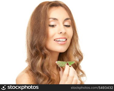 picture of woman with green leaf over white