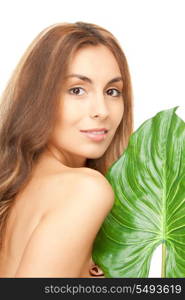 picture of woman with green leaf over white