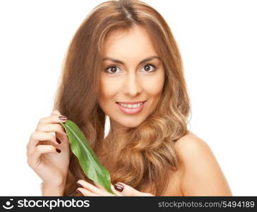 picture of woman with green leaf over white