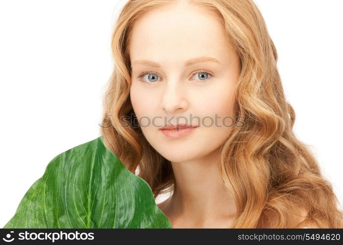 picture of woman with green leaf over white