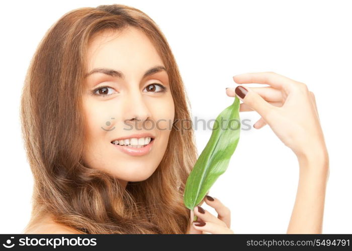 picture of woman with green leaf over white