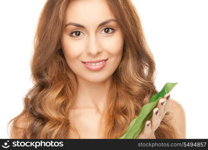 picture of woman with green leaf over white